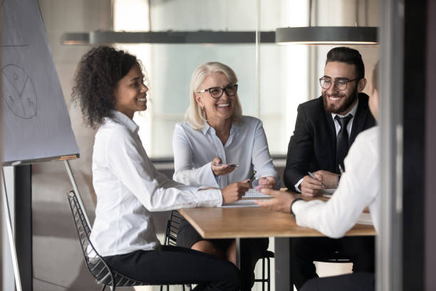 istock Multinational cheerful office workers chatting at briefing in conference room 1186185268