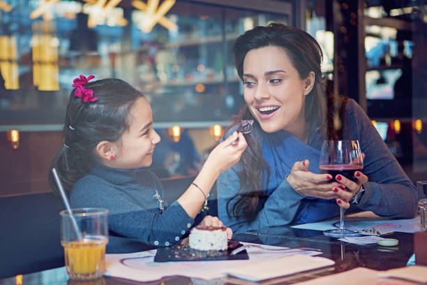 istock Daughter is feeding her mother with cake 1186191502