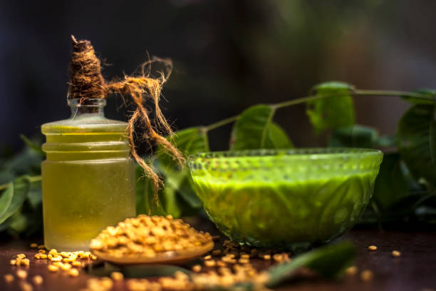 istock All scalp related problems solution lotion or shampoo in a glass bowl consisting of some neem leaves, fenugreek seeds and olive oil. Shot of fresh leaves of Neem tree,fenugreek seeds,pack,& olive oil. 1186197563