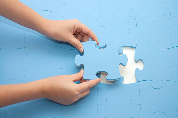istock Hand collecting a part of  puzzle 118619773