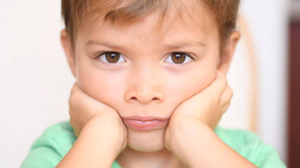 istock Sad bored little child boy close up 1186200548
