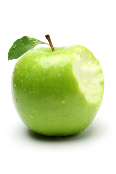 bite on a green apple - apple granny smith apple green leaf fotografías e imágenes de stock