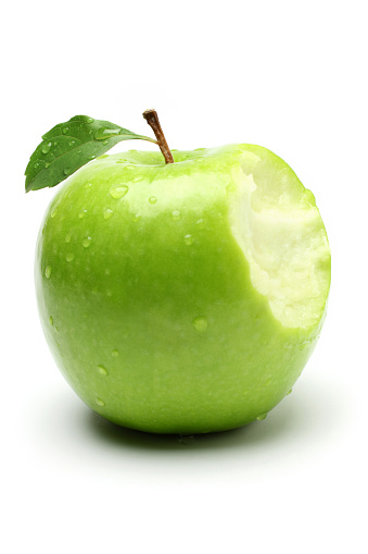 A bite on a green apple, isolated on white background.