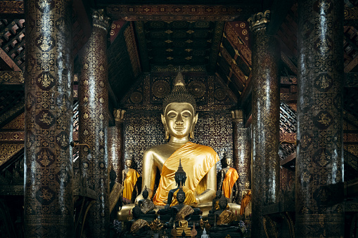 Impessive large Golden Buddha Statue from the 16th century inside the Wat Xienthong Temple, Monastery Complex. Wat Xieng Thong is the most spectacular temple in Lao. Luang Prabang, Laos, Southeast Asia