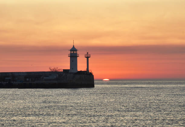 istock Sunrise at the lighthouse on the Sea 1186211161
