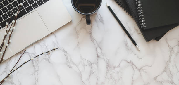 istock Top view of modern workplace with laptop computer and office supplies on marble table 1186211372