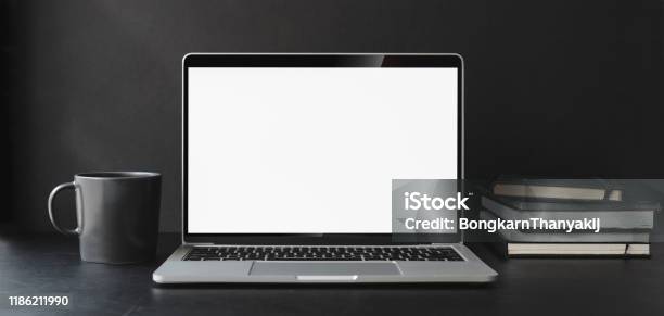 Cropped Shot Of Modern Office Room With Blank Screen Laptop Computer And Office Supplies Stock Photo - Download Image Now