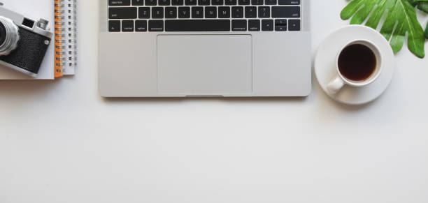 istock Top view of designer workplace with laptop computer and camera 1186212060