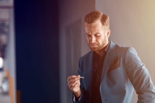 istock Displeased handsome businessman holding a cigarette 1186222407