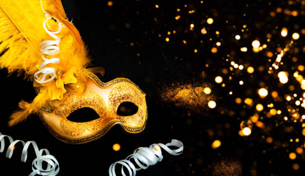 istock Masquerade mask on black background with confetti. Blurred effect. Close-up 1186232074