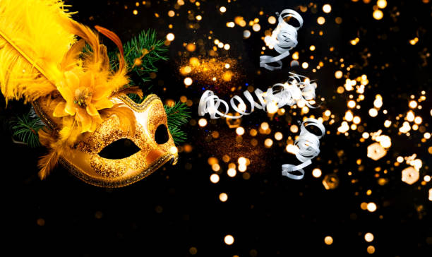 istock Masquerade mask on black background with confetti. New Years decor. Blurred effect. Close-up 1186232143