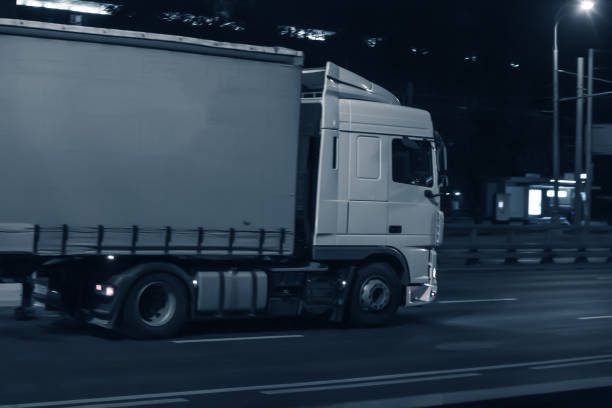 istock truck moving on night city 1186235333