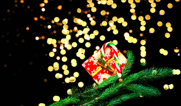 istock Christmas presents on black background with sparkles. Blurred effect. Close-up 1186239798