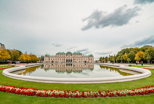 Vienna , Austria- October 3, 2019: The Belvedere is a historic building complex in Vienna, Austria, consisting of two Baroque palaces (the Upper and Lower Belvedere), the Orangery, and the Palace Stables. The buildings are set in a Baroque park landscape in the third district of the city, on the south-eastern edge of its centre. It houses the Belvedere museum. The grounds are set on a gentle gradient and include decorative tiered fountains and cascades, Baroque sculptures, and majestic wrought iron gates. The Baroque palace complex was built as a summer residence for Prince Eugene of Savoy.
