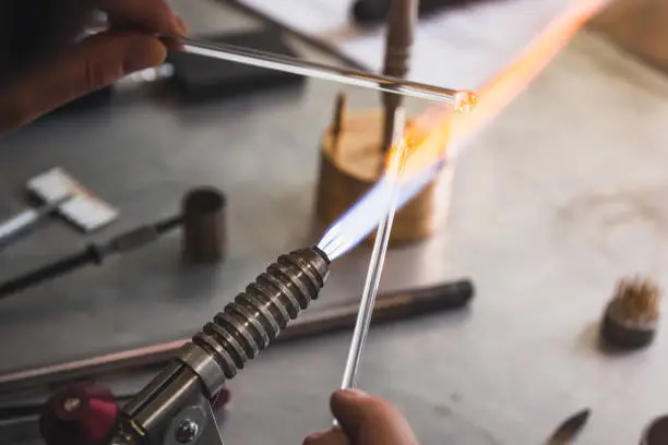 Lampworker workshop. Glassblowing hand tools. Lampworker workshop. Glass on fire. Master at work with fires.