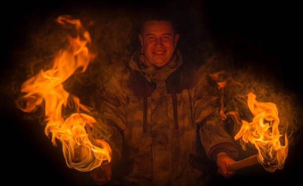 istock A man with a burning torch in the woods. 1186245811