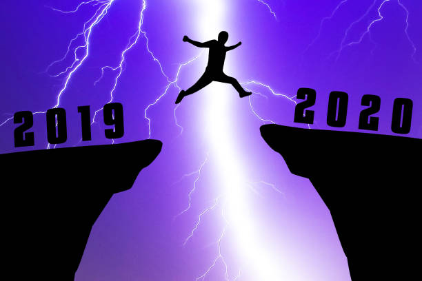 istock Silhouette young man jumping from 2019 to 2020 year 1186246919