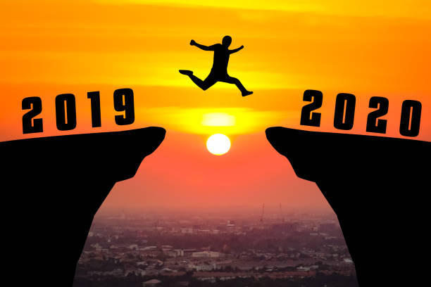 istock Silhouette young man jumping from 2019 to 2020 years 1186246927