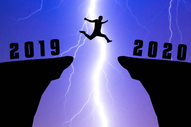 istock Silhouette young man jumping from 2019 to 2020 years 1186246929