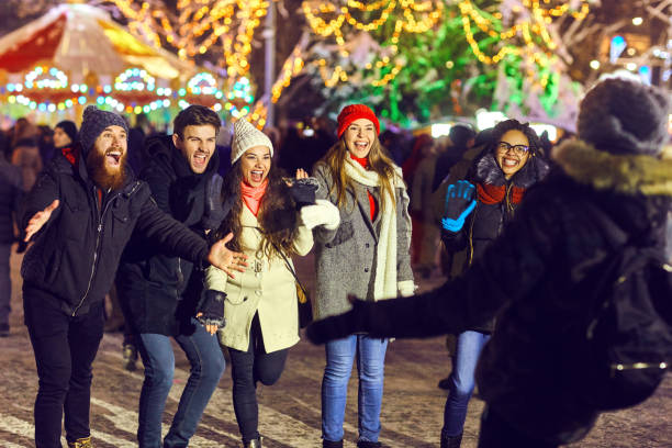 istock Cheerful friends meeting on winter fair 1186247054