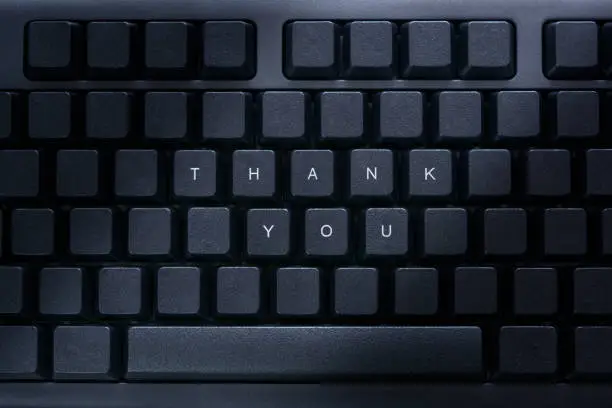 text "thank you" on the black keyboard. Thank-you day
