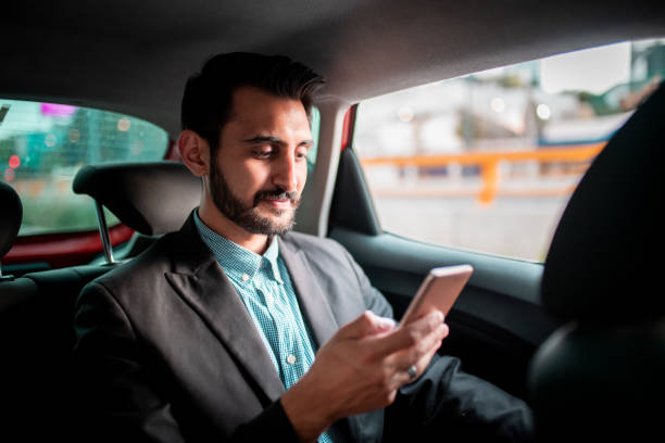 istock Businessman driving in a car and text messaging 1186252187