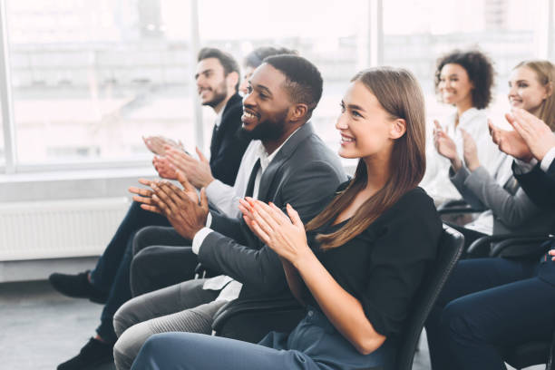 istock Diverse business team greeting speaker with applause 1186253685