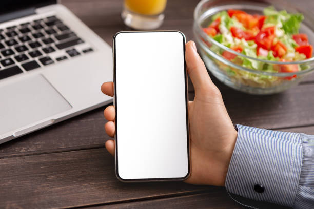 istock Modern smartphone with blank white screen in male hand, closeup 1186254946