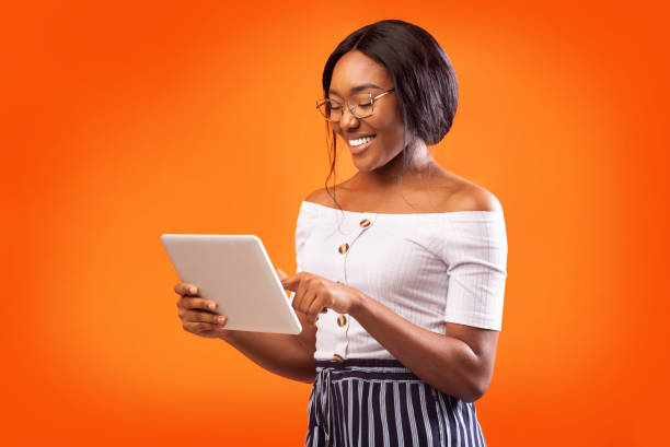 istock Happy African American Woman Using Digital Tablet Standing, Studio Shot 1186256237