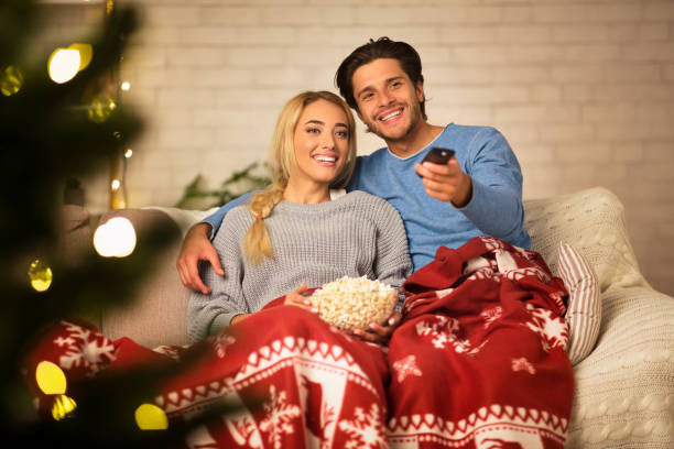 istock Watching Christmas shows together. Couple bonding to each other 1186256946