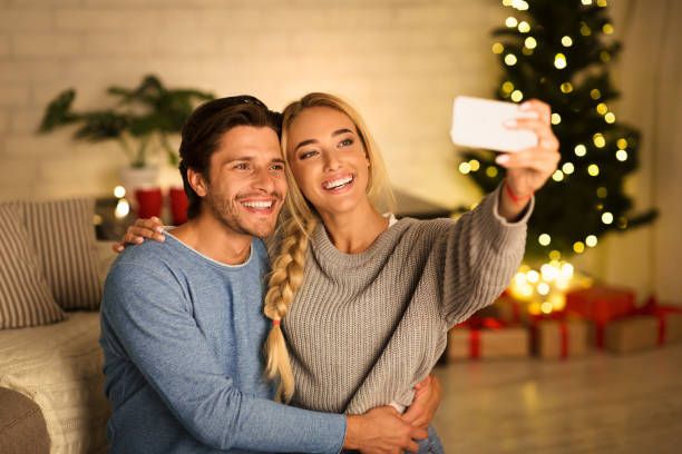 istock Loving millennial couple making selfie on Christmas eve 1186261002