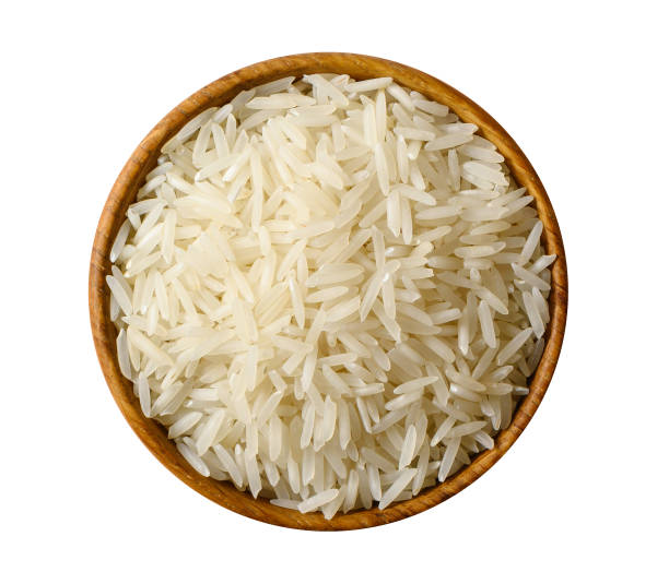 Dry white long rice basmati isolated on white background. Wooden bowl with white long rice basmati isolated on white background. Top view rice food staple stock pictures, royalty-free photos & images