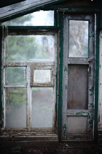 Old window frame with peeling paint and dirty glass.