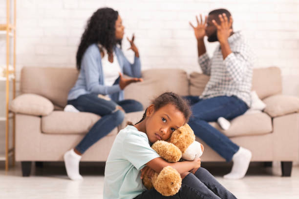 istock Child suffering from parents quarrels, sitting and cuddling teddy bear 1186268808