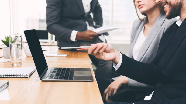 istock Colleagues discussing new project, poining on laptop 1186269919