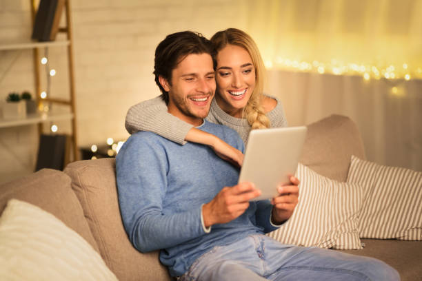 istock Happy couple having video-call on tablet, free space 1186271115