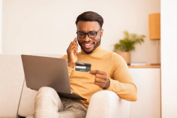 istock Guy talking on phone shopping online sitting on couch indoor 1186271230