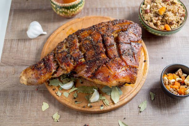 roast pork meat but with a bone on a wooden board stock photo
