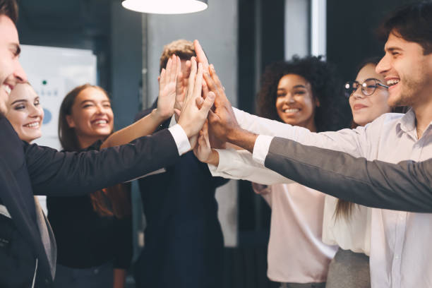 istock Teambuilding and unity. Happy coworkers giving high five 1186272382