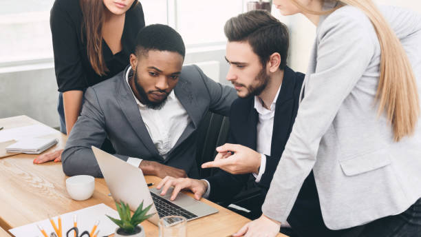 istock Analyzing fresh data. Serious business team looking at laptop 1186275013