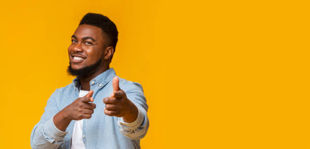 istock Handsome afro guy pointing fingers at camera and smiling 1186277662