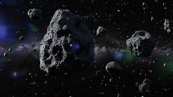 asteroids in deep space surrounded by dust