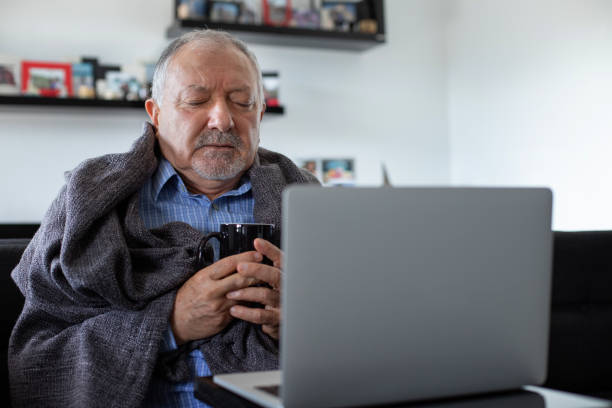istock A senior businessman working at home office when he is flu and cold 1186280290