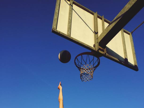 istock Playing basketball outdoors 1186280649