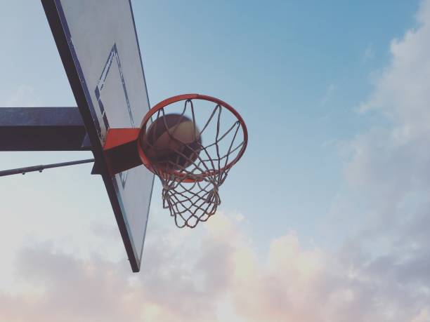 istock Playing basketball outdoors 1186280756