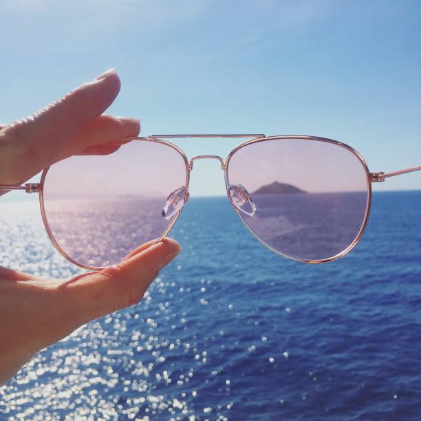 istock Pink sunglasses against sea and mountain 1186280809