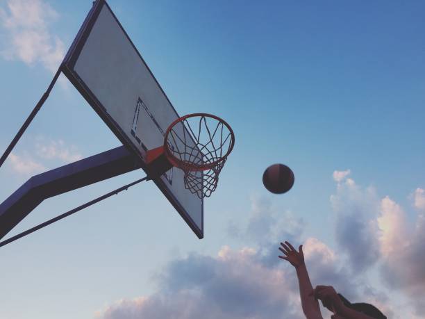 istock Playing basketball outdoors 1186282817