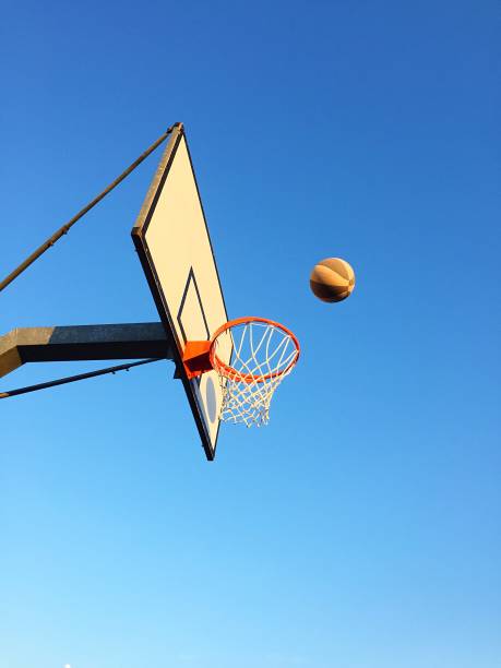 istock Playing basketball outdoors 1186282883