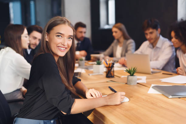 istock Smiling businesswoman with colleagues working on background 1186283902