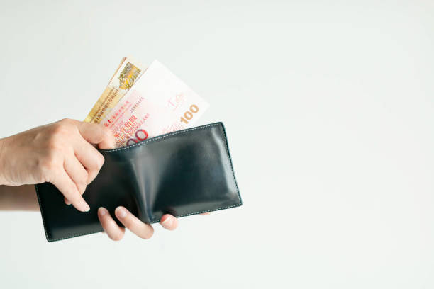 istock Hands picking Hong Kong money (Dollar Hong Kong or HKD) from short wallet for payment. 1186283932